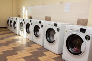a row of washing machines in a laundry room at Monada Hotel & Hostel in Uzhhorod