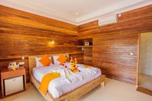 Ein Bett oder Betten in einem Zimmer der Unterkunft Dinatah Lembongan Villas