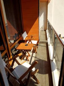 een balkon met tafels en stoelen in een gebouw bij Apartment By The Sea in Pomorie