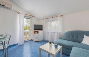 a living room with a couch and a table at Maja Apartment 2 in Funtana