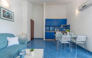 a living room with a couch and a table and chairs at Maja Apartment 2 in Funtana