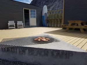 a grill with a sign that reads outdoor beach camp at Lofoten Beach Camp in Ramberg