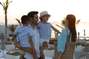 a family standing next to the beach at Jumeirah Burj Al Arab Dubai in Dubai