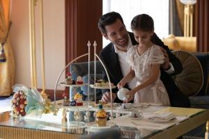 a man and a woman cutting a wedding cake at Jumeirah Burj Al Arab Dubai in Dubai