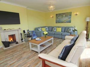 a living room with a couch and a fireplace at Windrush in Newquay