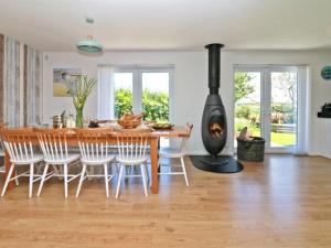 a kitchen and dining room with a wood stove at Penhaven in Bude