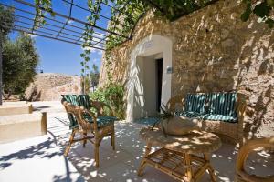 a patio with two chairs and a table at Tenuta De Marco in Presicce