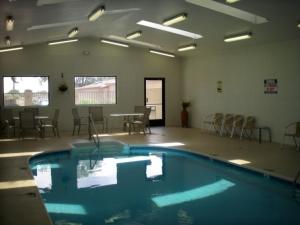 
a room with a pool and chairs and a pool table at Wetherill Inn in Kayenta
