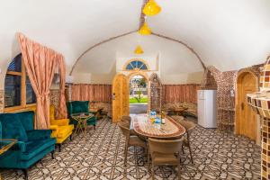 a living room with a table and chairs at The Dream Compound- by Biankini in Kalia
