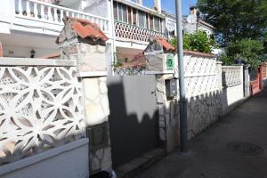 a white fence with a door on a street at Orlina in Empuriabrava