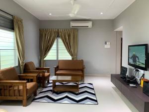 a living room with a couch and a tv at Traditional Villa with Modern Design 3R2B in Ipoh
