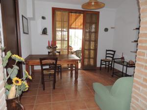 a dining room with a wooden table and chairs at Agriturismo Podere Borgognano in Massa Marittima +49 photos