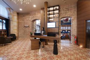 a woman sitting at a desk in a lobby at Mercure Istanbul Sirkeci in Istanbul