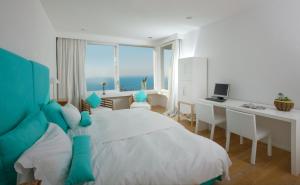 a bedroom with a bed and a desk with a computer at Relais Blu in Massa Lubrense