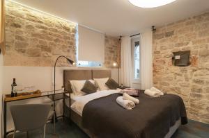 a bedroom with a bed with two stuffed animals on it at Luxury rooms 7heaven Palace in Split