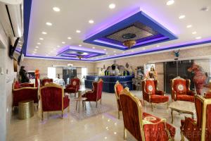 a restaurant with red chairs and a purple ceiling at The Dream Compound- by Biankini in Kalia +118 photos
