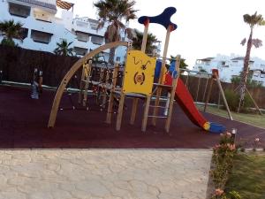 a playground with a slide and a slideintend at Apartamento Carlos in Rota