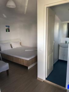 a small bedroom with a bed and a sink at Estelle in Costinesti +24 photos