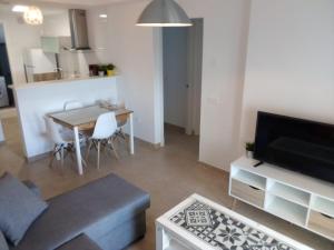 a living room with a couch and a table at Apartamento Carlos in Rota