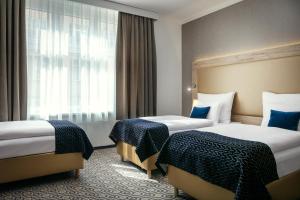Postel nebo postele na pokoji v ubytování Astoria Hotel + 31 fotografií