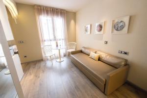 a living room with a couch and a table at Hotel & Spa Princesa Munia in Oviedo