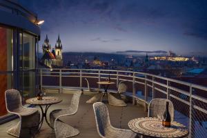 a balcony with tables and chairs and a view of a city at Astoria Hotel in Prague +38 photos