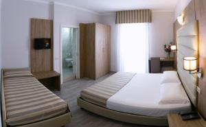 a hotel room with a bed and a bathroom at Hotel Myosotis in Riccione +41 photos