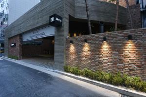 a brick building with lights on the side of it at Hotel March in Daejeon