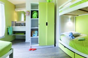 a bedroom with a bunk bed with green walls at VVF Île de Ré Sainte-Marie-de-Ré in Sainte-Marie-de-Ré