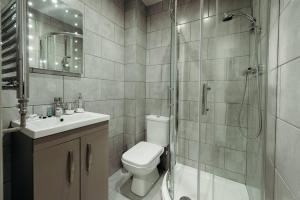 a bathroom with a shower and a toilet and a sink at Halifax House, Studio Apartment 209 in Halifax