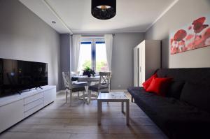 a living room with a couch and a table at Apartament Grey in Busko-Zdrój