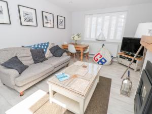 a living room with a couch and a table at Upper Deck in Dartmouth