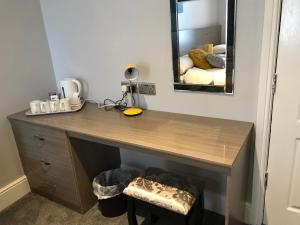 a wooden desk in a room with a mirror at Lexham Hotel in Blackpool