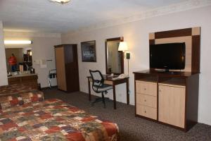 
a hotel room with a bed and a television at Wetherill Inn in Kayenta
