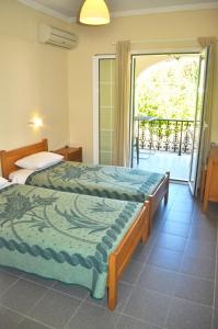Ένα ή περισσότερα κρεβάτια σε δωμάτιο στο Holiday Apartments yannis on Agios Gordios beach in Corfu