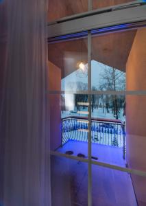 a room with a window with a view of a balcony at Laurentroom Park&Fountain in Ukmergė