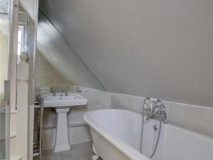 a white bathroom with a tub and a sink at Holiday Home Ephraim-2 by Interhome in Royal Tunbridge Wells