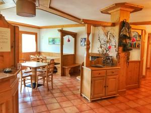 a kitchen and dining room with a table and chairs at Eco-Baita Natura Spensierata in Canale San Bovo