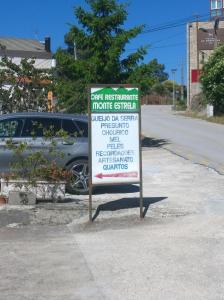 a sign on the side of a street with a car at Monte Estrela in Sabugueiro