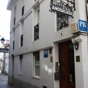 a building with a sign on the side of it at Hostal Anosa Casa in Santiago de Compostela +12 photos
