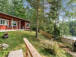 a house with a fence and a bench in front of it at Holiday Home Koivula by Interhome in Vuoriniemi