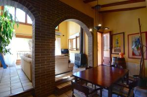 a living room with a table and a brick wall at CASA TERESA in Albanya