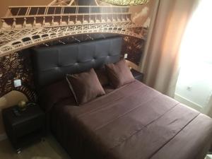 a bedroom with a large bed in front of the eiffel tower at Piso cerca del Toralin y La Rosaleda in Ponferrada