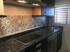 a kitchen with a sink and a counter top at Piso cerca del Toralin y La Rosaleda in Ponferrada