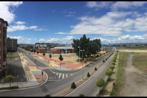 an empty street in a city under a cloudy sky at Piso cerca del Toralin y La Rosaleda in Ponferrada