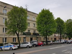 a row of cars parked in front of a hotel at Hotel Iskra in Rzeszów