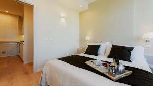 a hotel room with a large bed with a tray on it at Bologna Dreams in Bologna