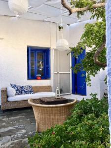 a patio with a couch and a blue door at Rhodes Summer House in Gennadi