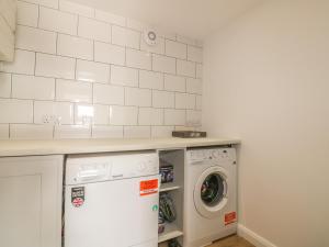 a laundry room with a washer and dryer at The Beach Halt in Perranporth