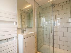 a bathroom with a sink and a shower at The Beach Halt in Perranporth